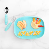 Bumkins Silicone Grip Tray: Blue holds apple slices, hummus, and cheese triangles on a marble background with blue utensils nearby.