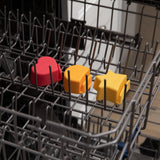 Bumkins Silicone Little Dipper 3-Pack: Tutti-Frutti sits in the top rack of an open dishwasher.