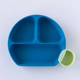 A dark blue plate with a green Bumkins Silicone Little Dipper Round 3-Pack: Taffy on a white background.