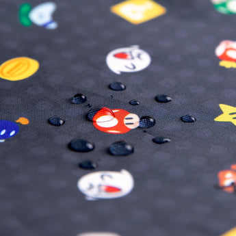 Close-up of water droplets on Bumkins Junior Bib: Super Mario™ Lineup.