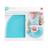 Bumkins Silicone Sensory Placemat: Blue is shown in a packaging box with a photo of a child and a front window partially showing the placemat.