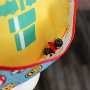 Close-up of berries in the pocket of a Bumkins SuperBib® 2 Pack: Super Mario™.