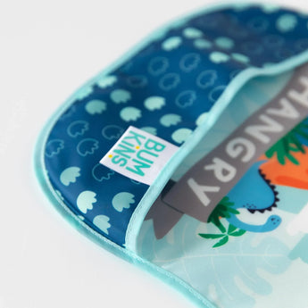 Close-up of a Bumkins SuperBib® 3 Pack: Hangry, Dinosaurs, Blue Tropic on a white background, with focus on the front pocket.