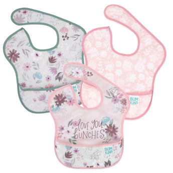 Bumkins SuperBib® 3 Pack: Love You Bunches includes three floral waterproof bibs with front pocket and adjustable neck closure.