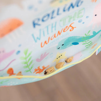 Close-up of cookies in the pocket of a Bumkins SuperBib® 3 Pack: Rolling With the Waves.