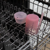 Bumkins Silicone Straw Cup with Lid: Pink sits in the top rack of an open dishwasher.