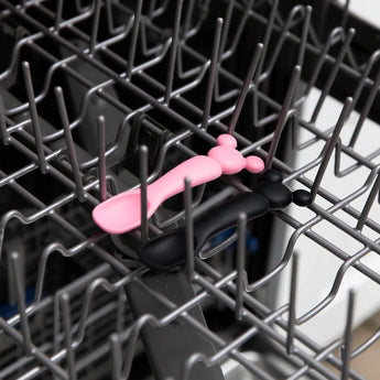 Bumkins Silicone Dipping Spoons: Minnie Mouse (Black and Pink) sit in the top rack of an open dishwasher.