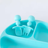 Close-up of Bumkins Silicone Chewtensils®: Blue in an empty section of a blue divided plate on a white background.