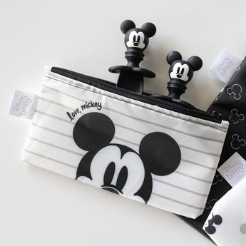 Bumkins Silicone Chewtensils®: Mickey Mouse peeks out from a Mickey Mouse-themed waterproof pouch on a white background.