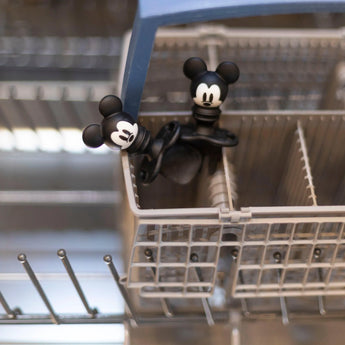 Bumkins Silicone Chewtensils®: Mickey Mouse sits in the utensil compartment of an open dishwasher.
