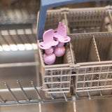 Bumkins Silicone Chewtensils®: Lavender sits in the utensil compartment of an open dishwasher.