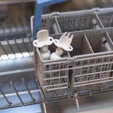 Bumkins Silicone Chewtensils®: Marble sits in the utensil compartment of an open dishwasher.