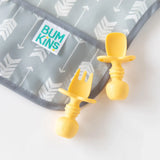 Close-up of Bumkins Silicone Chewtensils®: Pineapple on top of a gray arrow-print bib on a white background.