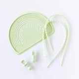 Bumkins Silicone Chewtensils®: Sage lays near a green silicone placemat and two green silicone tethers on a white background.