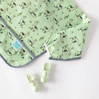 Bumkins Silicone Chewtensils®: Sage rest next to a green llama-patterned bib on a white background.