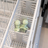 Bumkins Silicone Chewtensils®: Sage sits in the utensil compartment of an open dishwasher.