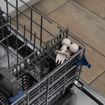 Bumkins Silicone Chewtensils®: Sand sit in the utensil compartment of an open dishwasher.