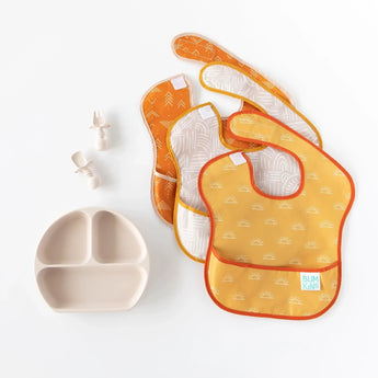 Bumkins Silicone Chewtensils®: Sand are displayed with a matching divided plate and three overlapping bibs on a white background.