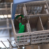 Bumkins Spoon + Fork: Jade sits in the utensil compartment of an open dishwasher.