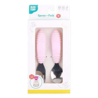 Bumkins Spoon + Fork: Pink is shown in a white packaging box with a clear front window displaying the set of utensils.
