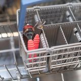 Bumkins Spoon + Fork set in red sits in the dishwashers gray basket, perfect for toddler self-feeding.