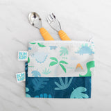 Bumkins Spoon + Fork: Tangerine peeks out from two dinosaur-print pouches on a marble background.