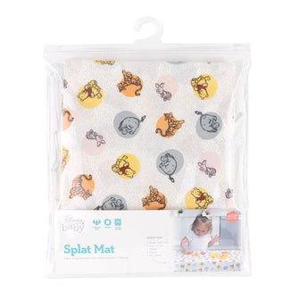Bumkins Splat Mat: Winnie and Friends is shown folded in plastic packaging bag with a hanger and cardboard insert.
