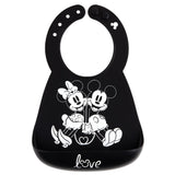 Bumkins Silicone Bib: Mickey + Minnie Mouse, made of black silicone, features a white illustration of Mickey and Minnie holding hands.