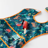 A red popsicle melts on top of Bumkins Super-Sized SuperBib®: Jungle on a white background.