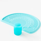 Bumkins Silicone Starter Cup: Blue sits in front of a blue placemat on a white background.