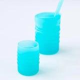 Bumkins Silicone Starter Cup: Blue sits in front of a larger blue cup on a white background.