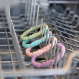 Bumkins Silicone Teething Rings 4 Pack: Spring sits in the top rack of an open dishwasher.