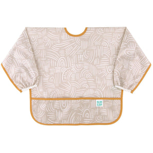 Bumkins Sleeved Bib: Wander is made of beige waterproof fabric with white abstract patterns, orange trim, front pocket, and elastic cuffs.