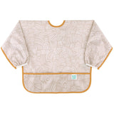 Bumkins Sleeved Bib: Wander is made of beige waterproof fabric with white abstract patterns, orange trim, front pocket, and elastic cuffs.