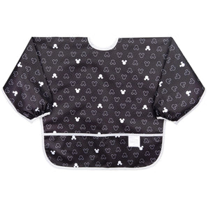 Bumkins Sleeved Bib: Mickey Mouse Icon Black + White is made of black waterproof fabric with a white Mickey Mouse icon design & white trim.
