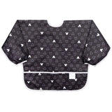 Bumkins Sleeved Bib: Mickey Mouse Icon Black + White is made of black waterproof fabric with a white Mickey Mouse icon design & white trim.