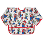 Bumkins Sleeved Bib: Super Mario™ Classic is a sleeved waterproof bib with video game character illustrations, red trim, front pocket.