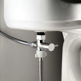 Close-up of a Bumkins Cloth Diaper Sprayer, showcasing the T-connector with shut-off valve attached to a white toilet.