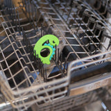 Bumkins Silicone Teether: Dinosaur sits in the top rack of an open dishwasher.