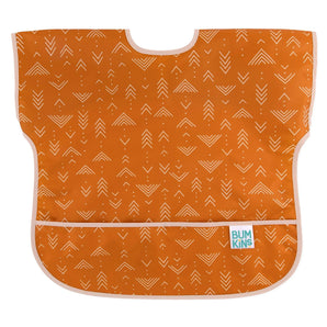 Bumkins Junior Bib: Grounded is made of orange waterproof fabric with a white arrow design, adjustable neck closure, and front pocket.