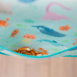 Close-up of pretzels in the pocket of a Bumkins Junior Bib: Ocean Life.