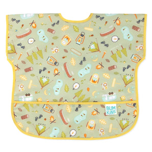 Bumkins Junior Bib: Camp Gear features camping illustrations on green waterproof fabric with a yellow trim and front pocket.