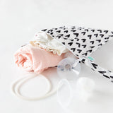 Bumkins Wet Bag: Hearts lays partially open on a white background with cloth diapers and breast pump parts spilling out.