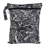 Bumkins Wet/Dry Bag: Be Kind features a white doodle print on black waterproof fabric with two zippered compartments.