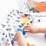 Close-up of a child reaching into a Bumkins Clear Travel Bag 3-Pack: Hearts filled with craft supplies.