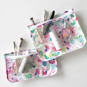 Two Bumkins Clear Travel Bag 3-Pack: Watercolor hold cosmetic items on a white background.