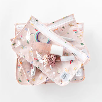 Bumkins Clear Travel Bag 3 Pack: Princess Magic filled with makeup sits stacked on a white background.