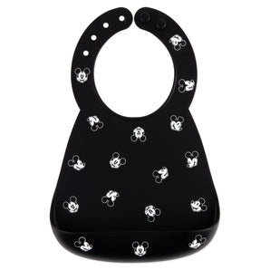 Bumkins Silicone Bib: Mickey Mouse Faces is made of black silicone and features a white Mickey Mouse face pattern.