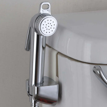 Close-up of a Bumkins Cloth Diaper Sprayer mounted to a white toilet.