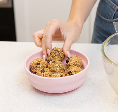 Finished no-bake lactation bites arranged in Bumkins silicone grip bowl, ready to eat.